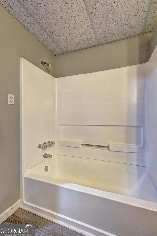 5621 Wildwood Trl, Lithonia, GA 30038 - full bathroom featuring wood finished floors, baseboards, and bathtub / shower combination