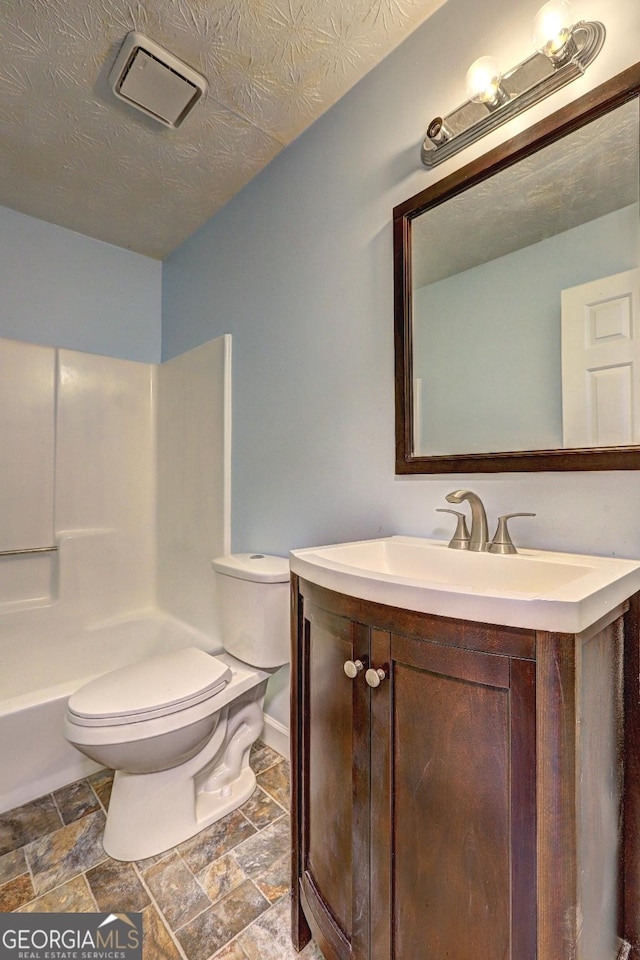 5621 Wildwood Trl, Lithonia, GA 30038 - full bathroom featuring toilet, visible vents, walk in shower, stone finish flooring, and vanity