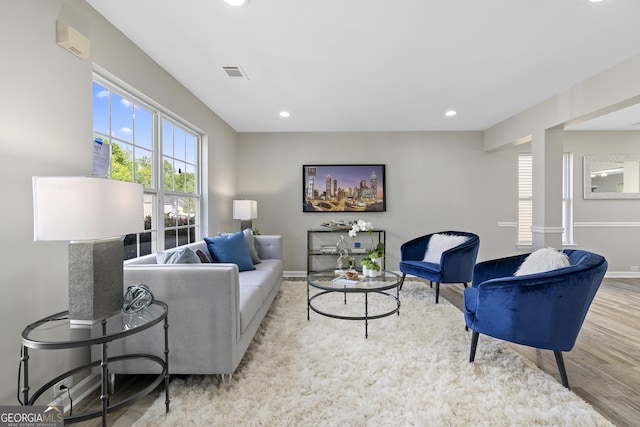 living area with baseboards, recessed lighting, wood finished floors, and visible vents