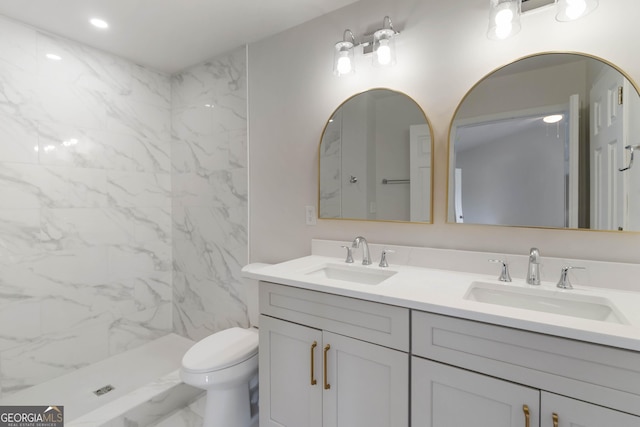 full bathroom with toilet, marble finish floor, double vanity, and a sink
