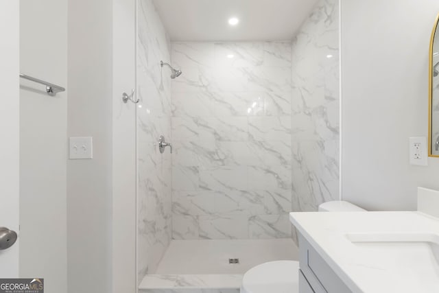 bathroom with a marble finish shower, recessed lighting, vanity, and toilet