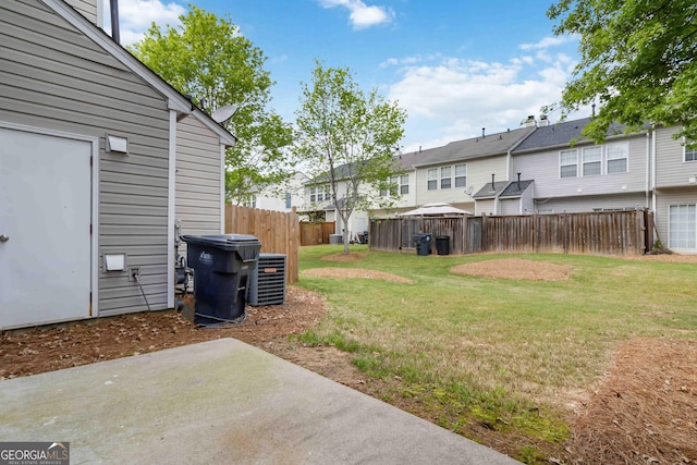 view of yard with a fenced backyard, a patio, cooling unit, and a residential view