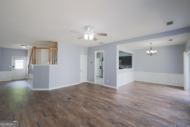 4205 Royal Regency Cir NW, Kennesaw, GA 30144 - unfurnished living room featuring a chandelier, a ceiling fan, stairs, wood finished floors, and a wainscoted wall