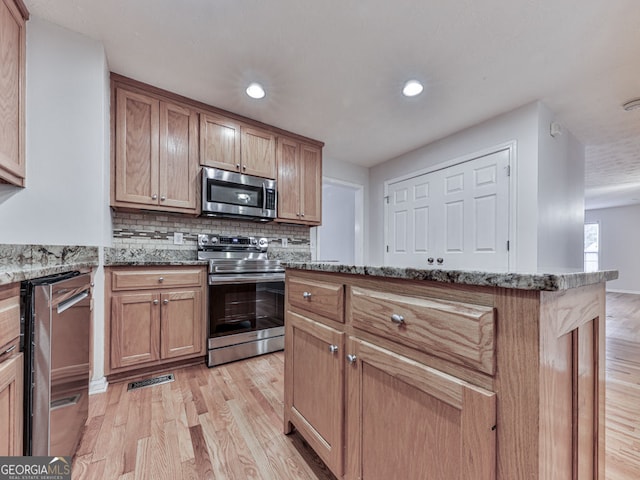 kitchen with tasteful backsplash, stainless steel appliances, recessed lighting, light wood finished floors, and stone counters