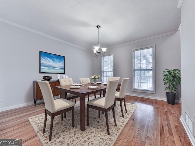 dining area featuring a notable chandelier, baseboards, and light wood-type flooring