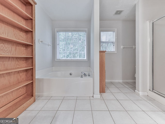 bathroom featuring a stall shower, visible vents, a garden tub, and tile patterned flooring