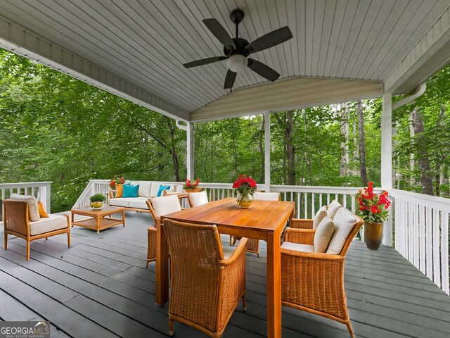 deck featuring outdoor dining space, ceiling fan, and outdoor lounge area