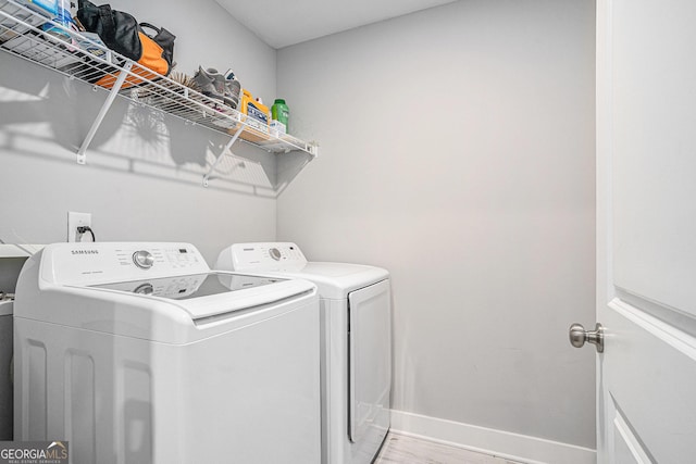 1702 Prospect Way, Conyers, GA 30094 - clothes washing area with baseboards, separate washer and dryer, laundry area, and light wood-style flooring