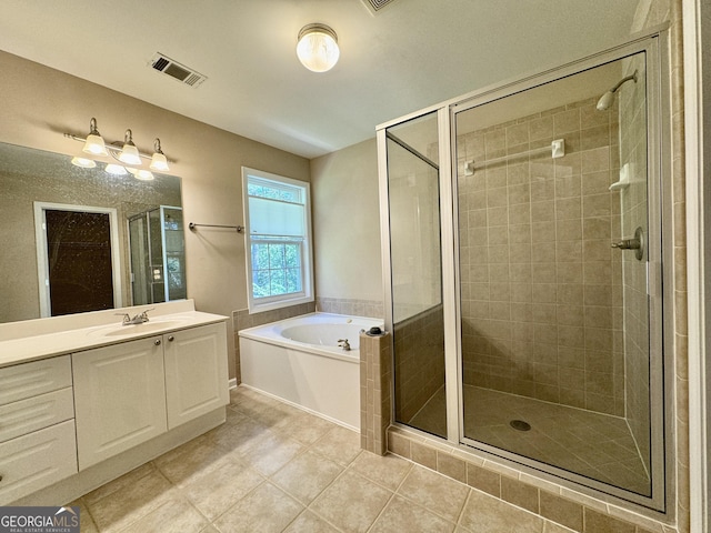 full bathroom featuring a shower stall, tile patterned flooring, visible vents, vanity, and a garden tub