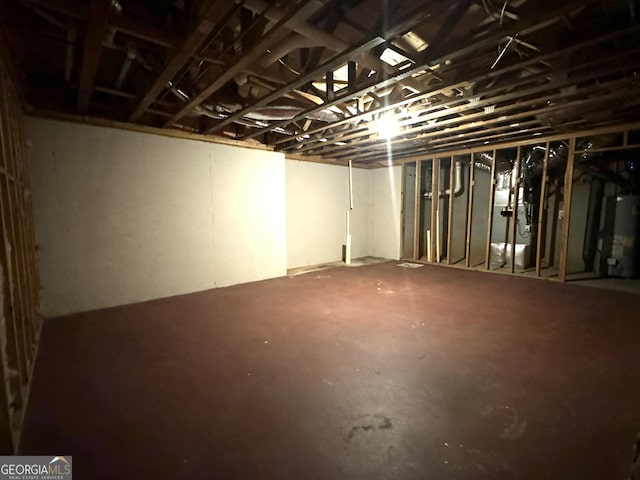 unfinished below grade area featuring water heater