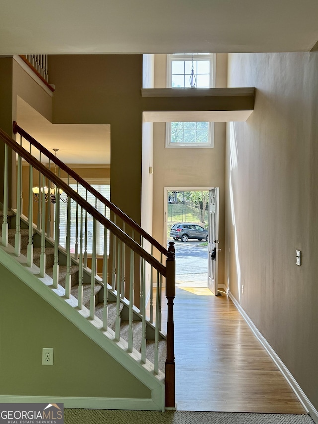 stairs featuring baseboards and wood finished floors