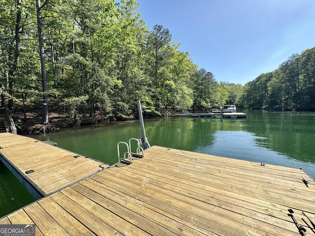 dock area with a view of trees and a water view