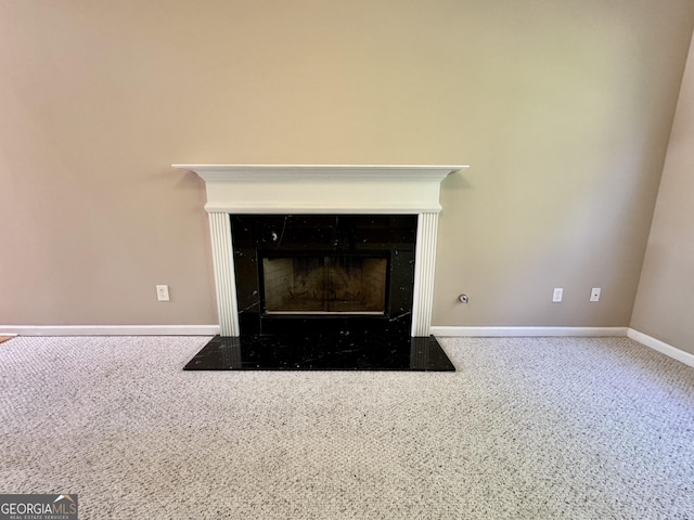 room details featuring baseboards and a fireplace