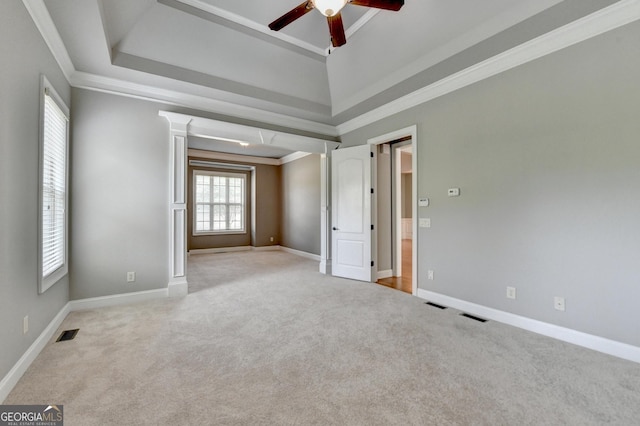 spare room featuring carpet flooring, a ceiling fan, visible vents, and ornamental molding