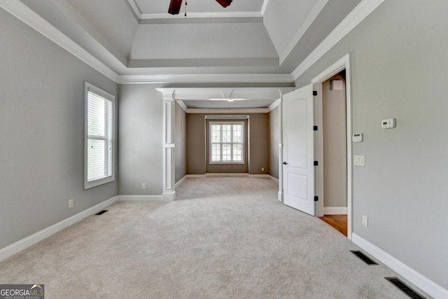 spare room featuring crown molding, light carpet, a ceiling fan, and visible vents