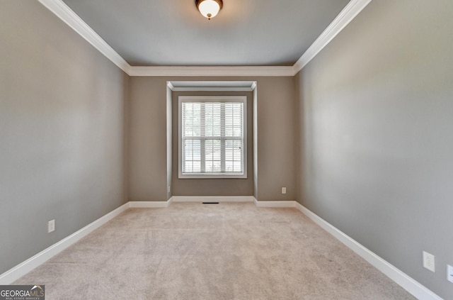 carpeted empty room with crown molding, baseboards, and visible vents