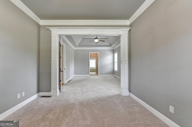 spare room featuring crown molding, ceiling fan, and light colored carpet
