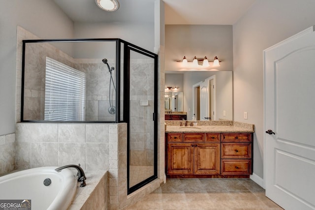 full bath featuring vanity, tile patterned floors, a garden tub, and a stall shower