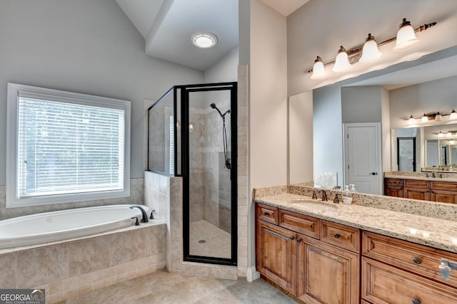 bathroom featuring vanity, tile patterned flooring, a bath, a shower stall, and vaulted ceiling