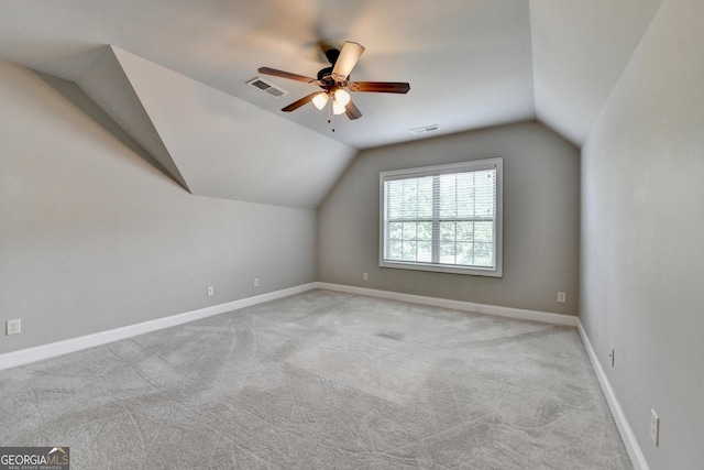 additional living space with carpet flooring, ceiling fan, visible vents, and lofted ceiling