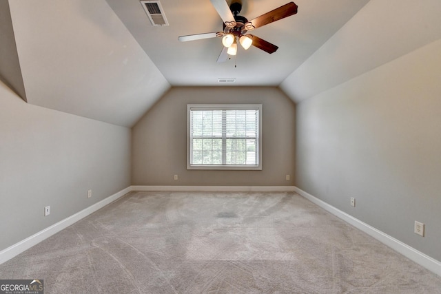 additional living space with visible vents, a ceiling fan, and lofted ceiling
