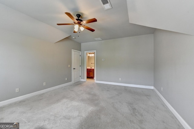 unfurnished bedroom with visible vents, light carpet, baseboards, connected bathroom, and a ceiling fan