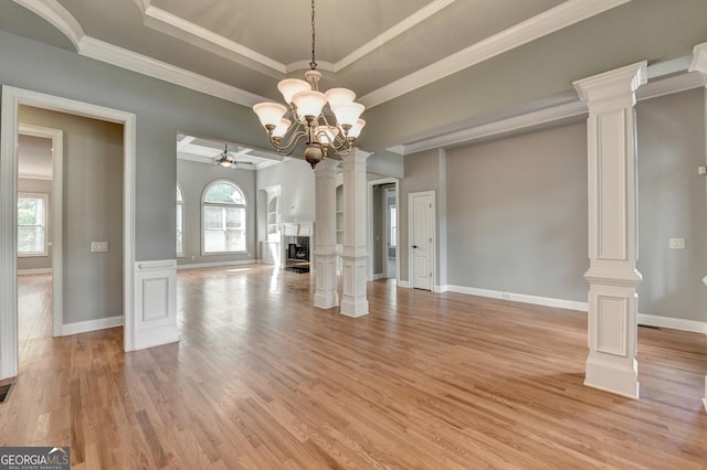 unfurnished living room featuring baseboards, decorative columns, ornamental molding, and light wood-style floors