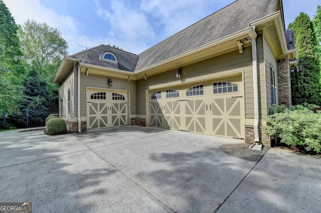 garage featuring concrete driveway