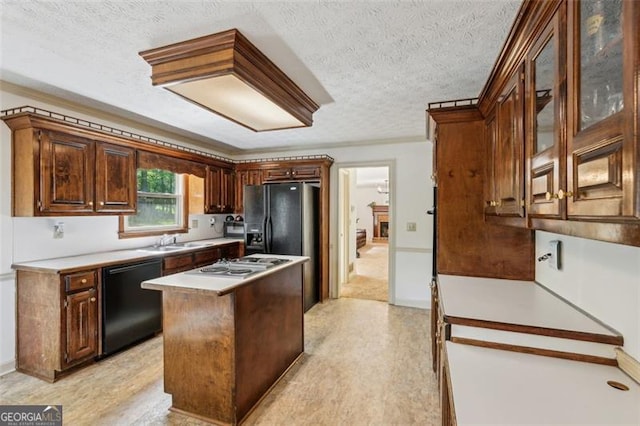 22 Oakwood Hills Dr, Suwanee, GA 30024 - kitchen featuring a center island, a sink, a textured ceiling, and black appliances
