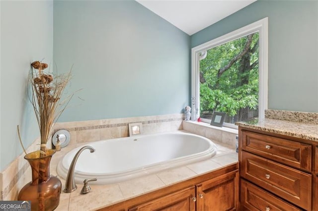 22 Oakwood Hills Dr, Suwanee, GA 30024 - bathroom with lofted ceiling, a garden tub, and vanity