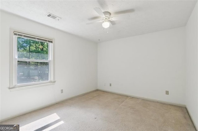 22 Oakwood Hills Dr, Suwanee, GA 30024 - spare room with light colored carpet, ceiling fan, visible vents, and baseboards