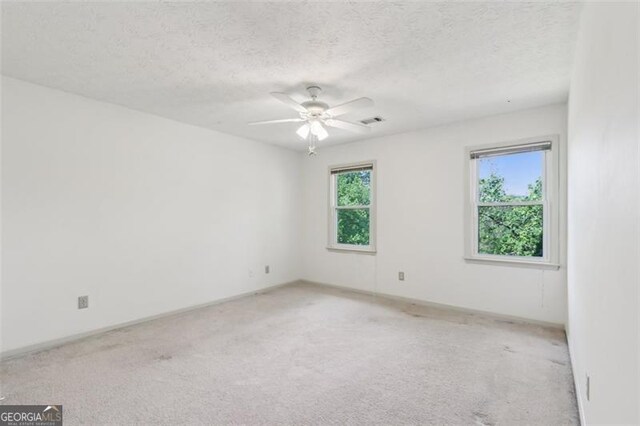 22 Oakwood Hills Dr, Suwanee, GA 30024 - empty room featuring a textured ceiling, visible vents, light carpet, and baseboards