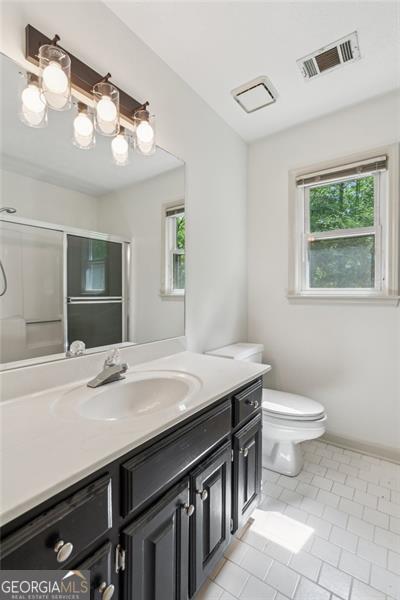 22 Oakwood Hills Dr, Suwanee, GA 30024 - full bath with a shower with door, visible vents, plenty of natural light, and tile patterned flooring