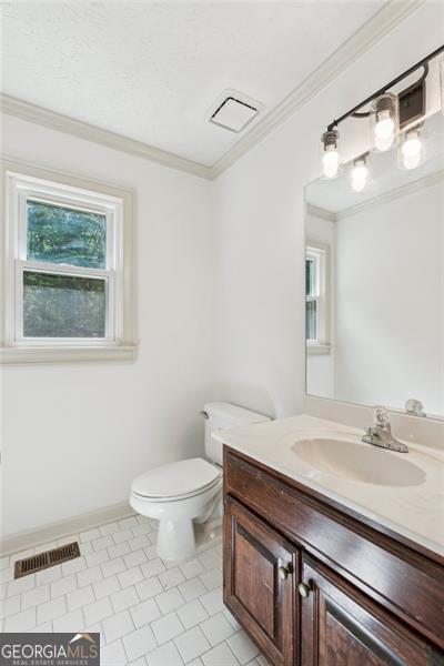 22 Oakwood Hills Dr, Suwanee, GA 30024 - bathroom featuring tile patterned floors, ornamental molding, toilet, and visible vents