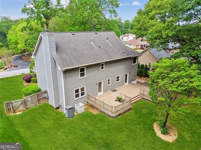 22 Oakwood Hills Dr, Suwanee, GA 30024 - back of house with fence, a shingled roof, a wooden deck, a chimney, and a yard