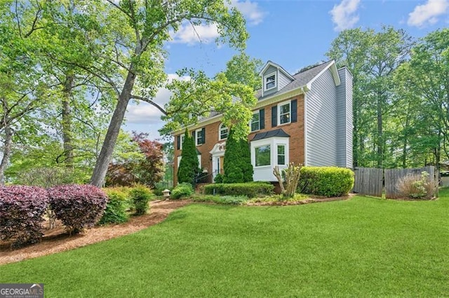 22 Oakwood Hills Dr, Suwanee, GA 30024 - view of front facade with fence, a chimney, and a front lawn