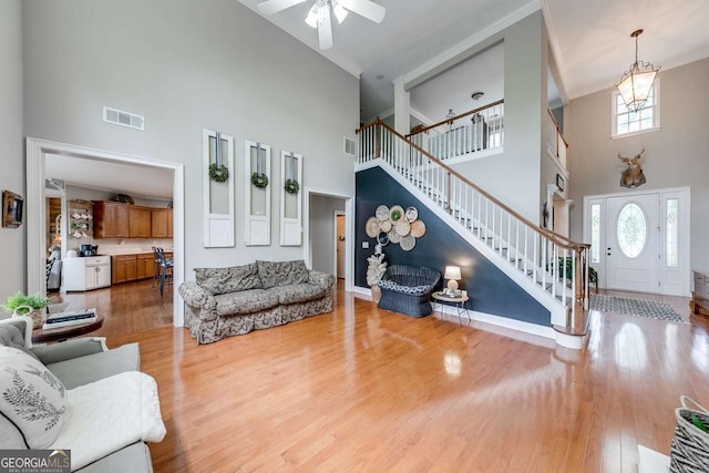 1738 Honey Tree Pl, Hoschton, GA 30548 - living area with a high ceiling, stairs, a ceiling fan, and wood finished floors