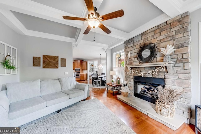 1738 Honey Tree Pl, Hoschton, GA 30548 - living room featuring coffered ceiling, beamed ceiling, wood finished floors, a ceiling fan, and a stone fireplace