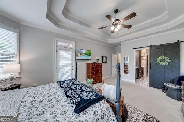 1738 Honey Tree Pl, Hoschton, GA 30548 - bedroom with a barn door, light carpet, a ceiling fan, crown molding, and a tray ceiling
