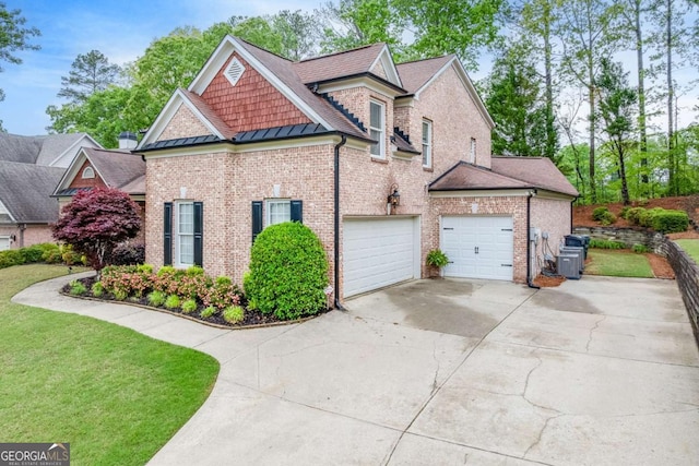 1738 Honey Tree Pl, Hoschton, GA 30548 - view of property exterior with a standing seam roof, driveway, brick siding, a yard, and a metal roof