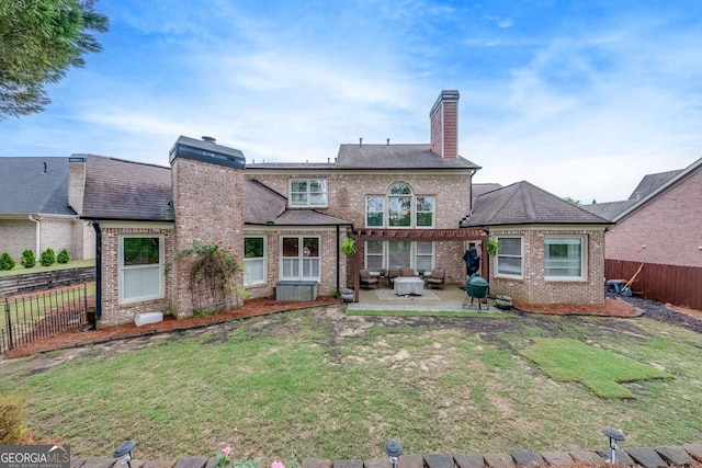 1738 Honey Tree Pl, Hoschton, GA 30548 - rear view of property featuring a chimney, brick siding, a pergola, and a patio