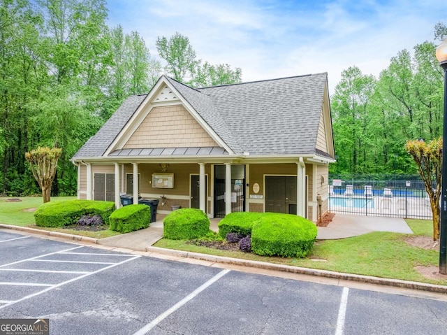 1738 Honey Tree Pl, Hoschton, GA 30548 - view of building exterior with a community pool and uncovered parking