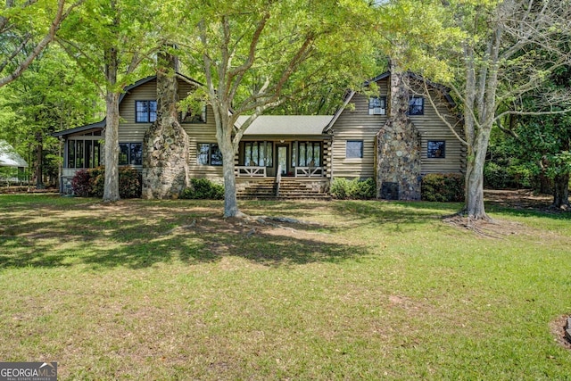 cabin featuring covered porch, log exterior, and a shingled roof