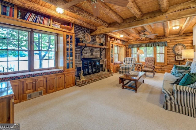 carpeted living area with wooden ceiling, ceiling fan, log walls, and visible vents