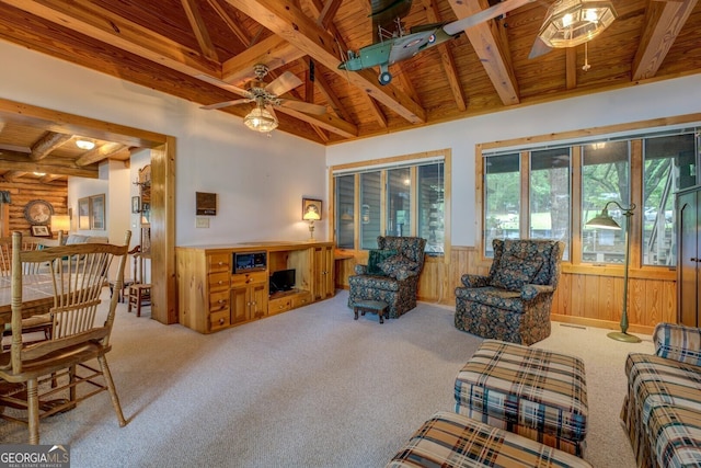 living room featuring a ceiling fan, carpet, a wainscoted wall, and wooden ceiling