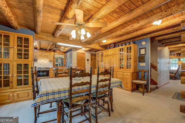 dining room featuring light colored carpet, ceiling fan, and wooden ceiling