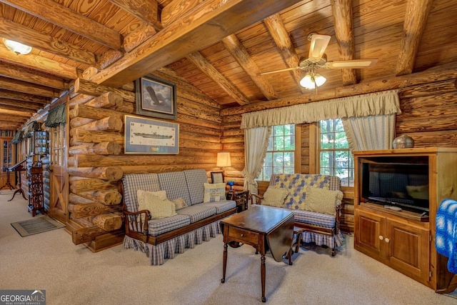 carpeted living room featuring vaulted ceiling with beams, a ceiling fan, rustic walls, and wooden ceiling