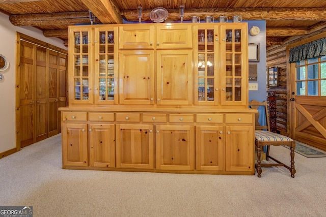 interior space with light colored carpet, wood ceiling, and beam ceiling