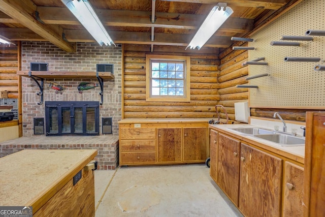 kitchen with a sink, log walls, open shelves, and beamed ceiling
