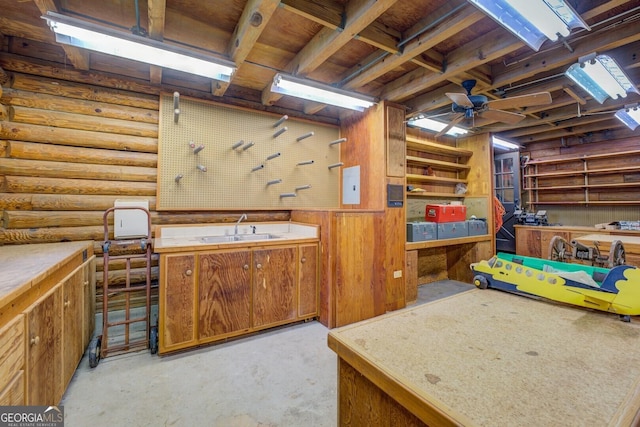 below grade area with a sink, ceiling fan, and a workshop area